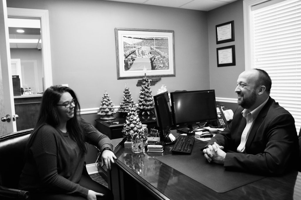 Michael Horton with an employee of The Farmers Bank of Westmoreland. 