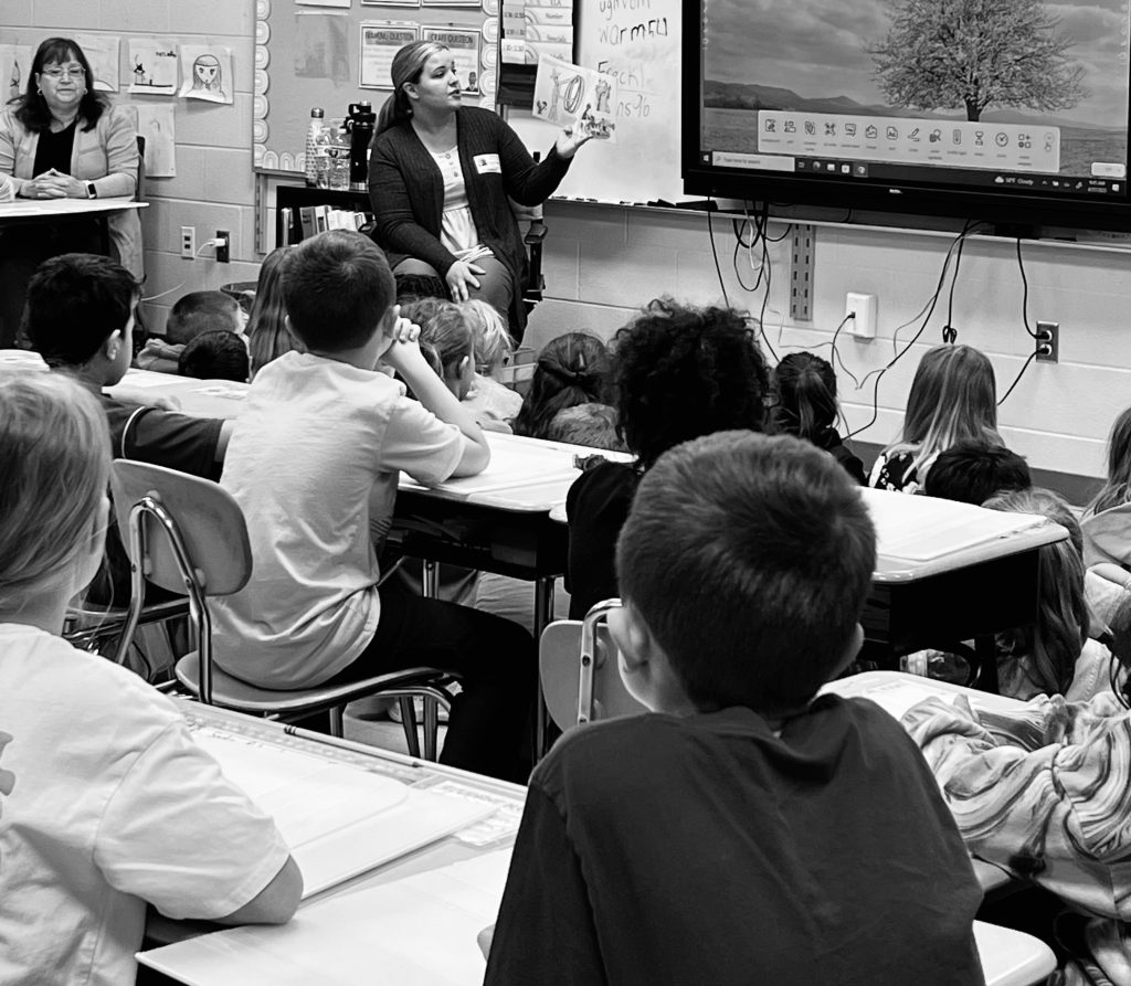 Brown reading to an elementary class during Teach Children to Save Week in April. 